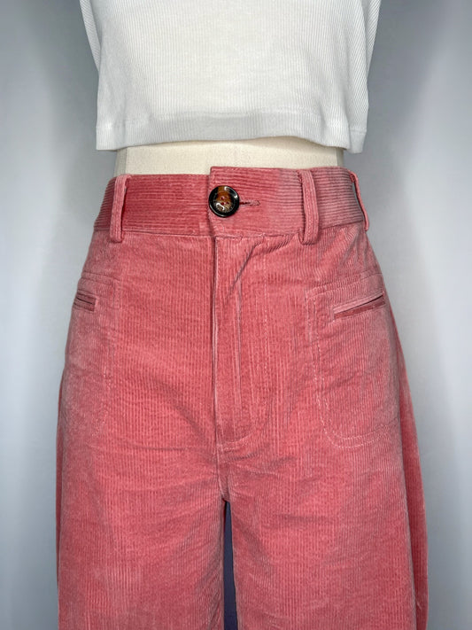 Close up of Saint Geraldine Wide-Leg Corduroy Pant in Pink, featuring the button, belt loops, and two front pockets.