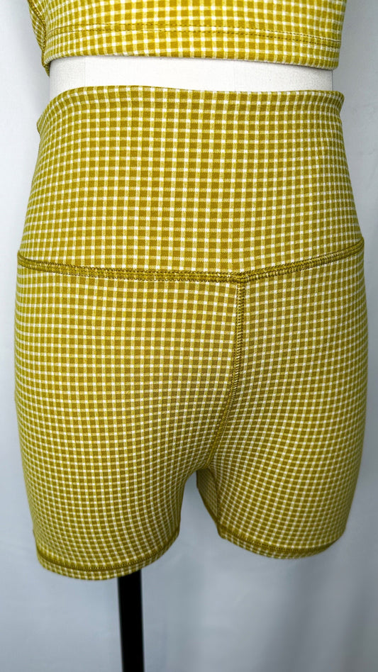 Up-close view of Madewell Flex High Rise Biker Shorts in gingham print and citrus lime color
