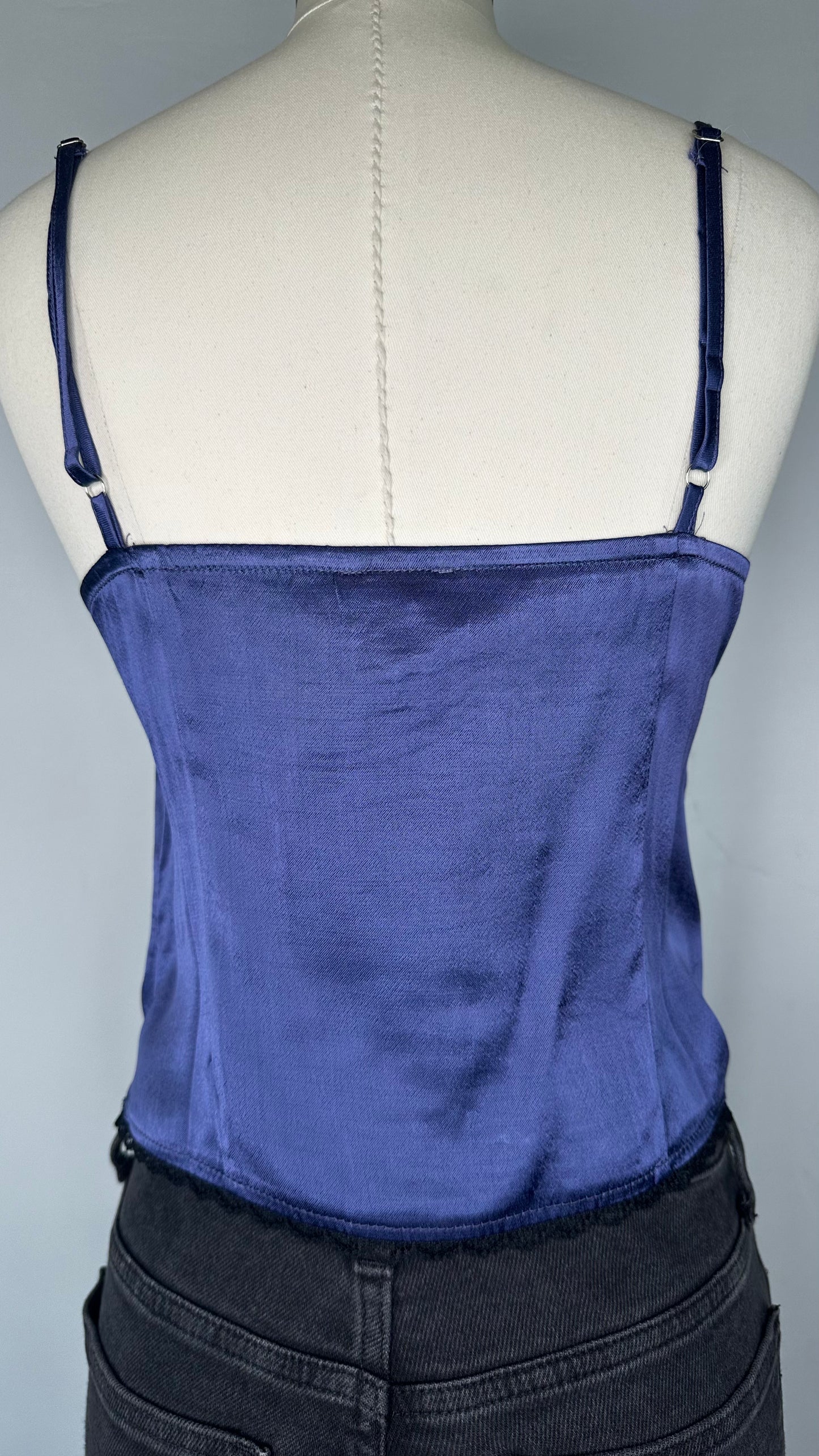 Back View of Sky to Moon Satin Lace Cami Top in Navy featuring the adjustable cami straps and a plain satin back with lace on the bottom hem.