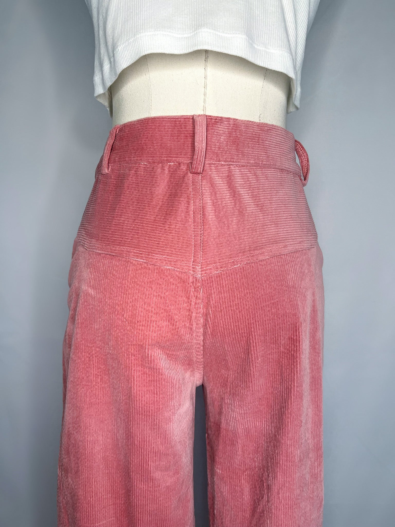 Back view of Saint Geraldine Wide-Leg Corduroy Pant in pink, featuring the yoke detailing and belt loops.