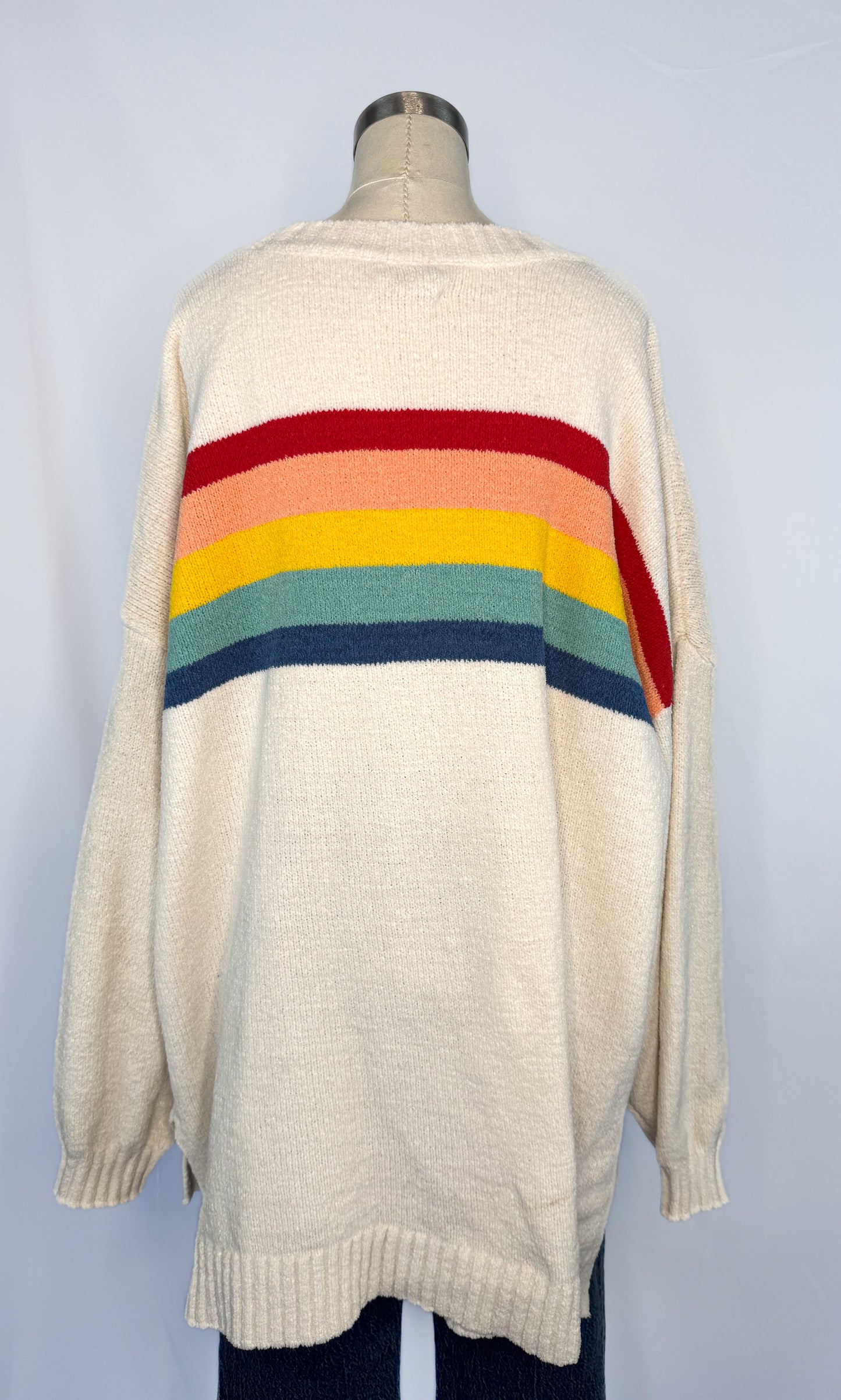 Back side of American Eagle Oversized Rainbow Stripe Sweater in Cream with the stripes continuing from the front.