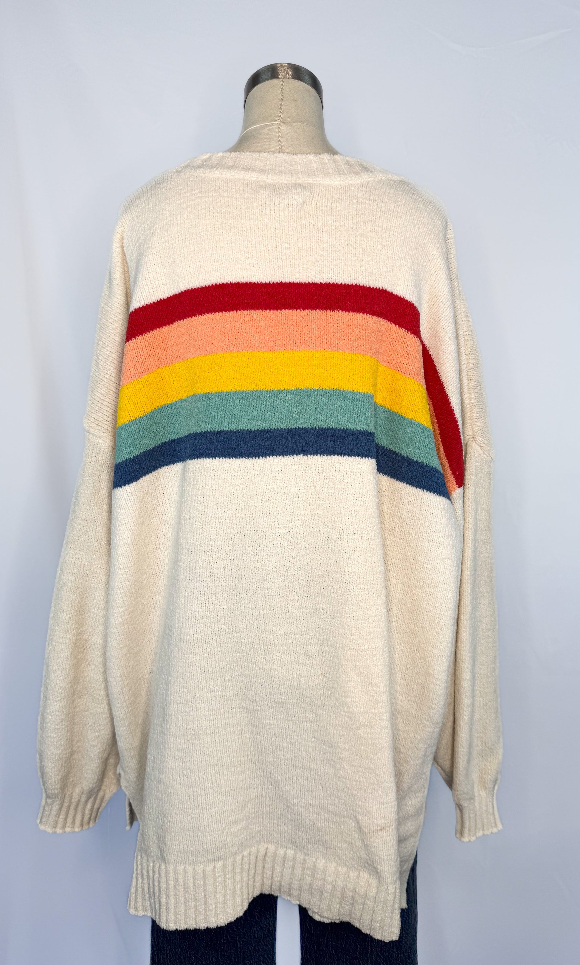 Back side of American Eagle Oversized Rainbow Stripe Sweater in Cream with the stripes continuing from the front.