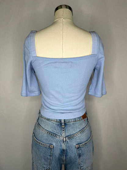 Back view of Urban Outfitters Square Neck Crop Top in Light Blue shown on a mannequin wearing light blue jeans and features the back side square neck line.