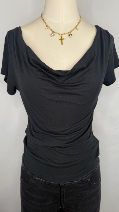 Front facing view of Silence + Noise Cowl Neck Top in Black featuring the cowl neckline. The top is style on a mannequin wearing a gold charm necklace and black jeans.