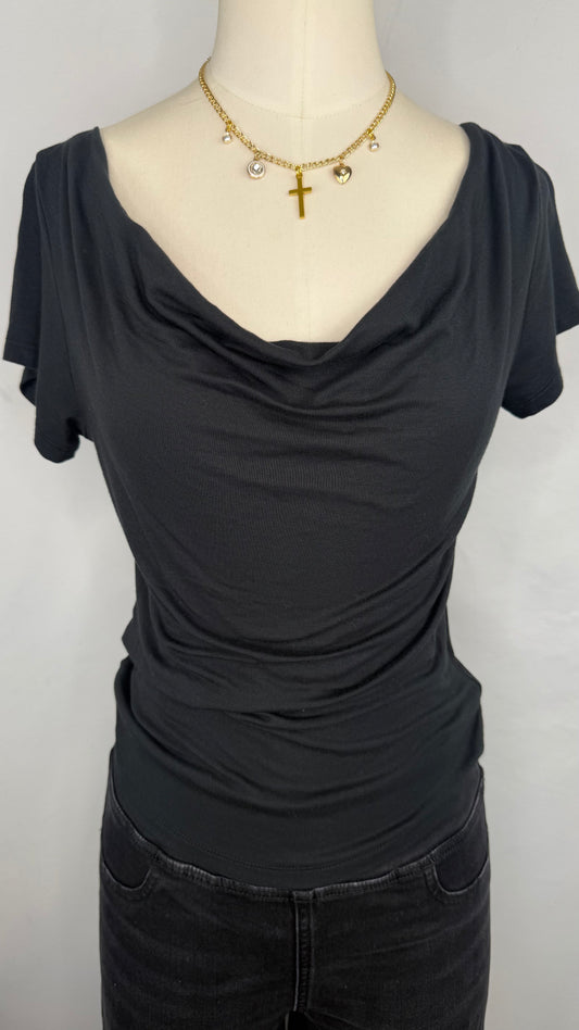 Front facing view of Silence + Noise Cowl Neck Top in Black featuring the cowl neckline. The top is style on a mannequin wearing a gold charm necklace and black jeans.