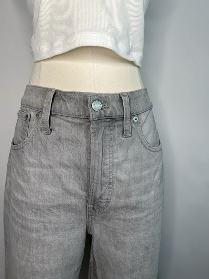 Close up of front of grey Madewell slim demi-boot jeans