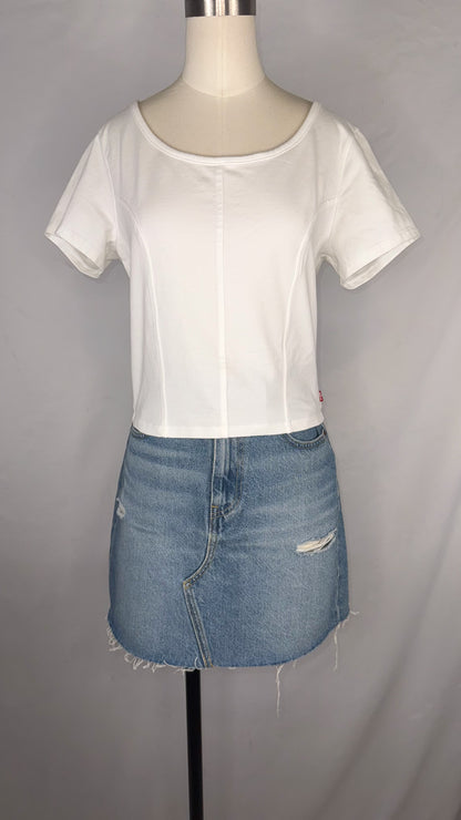 Front view of Levi's Corset T-Shirt in White size large with mannequin wearing the top paired with a light blue, distressed denim mini skirt.