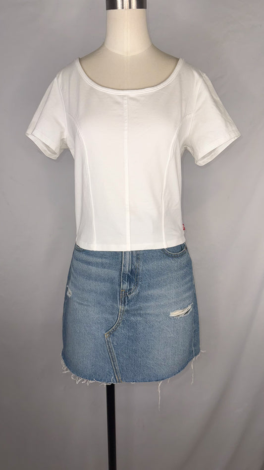 Front view of Levi's Corset T-Shirt in White size large with mannequin wearing the top paired with a light blue, distressed denim mini skirt.