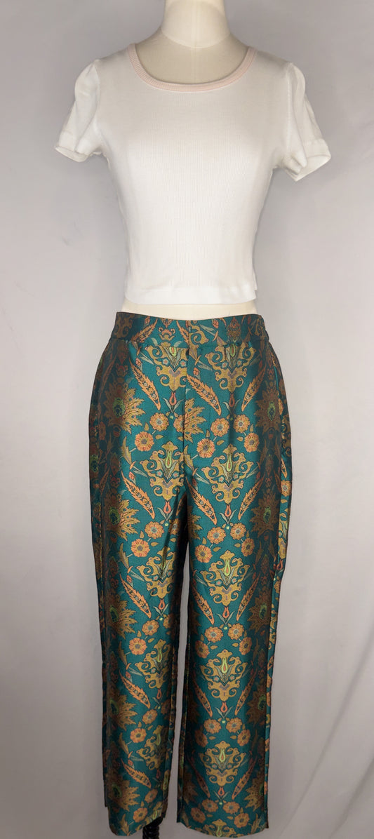 Front view of Maeve by Anthropologie Jacquard Trouser in Multi. The trousers are shown paired with a white, cropped tee. The trousers have a front hook closure and a button.