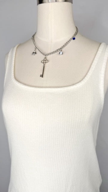 Up-close front facing view of Madewell Ribbed Square-Neck Tank Top in Lighthouse featuring the square neckline and silver charm necklace.