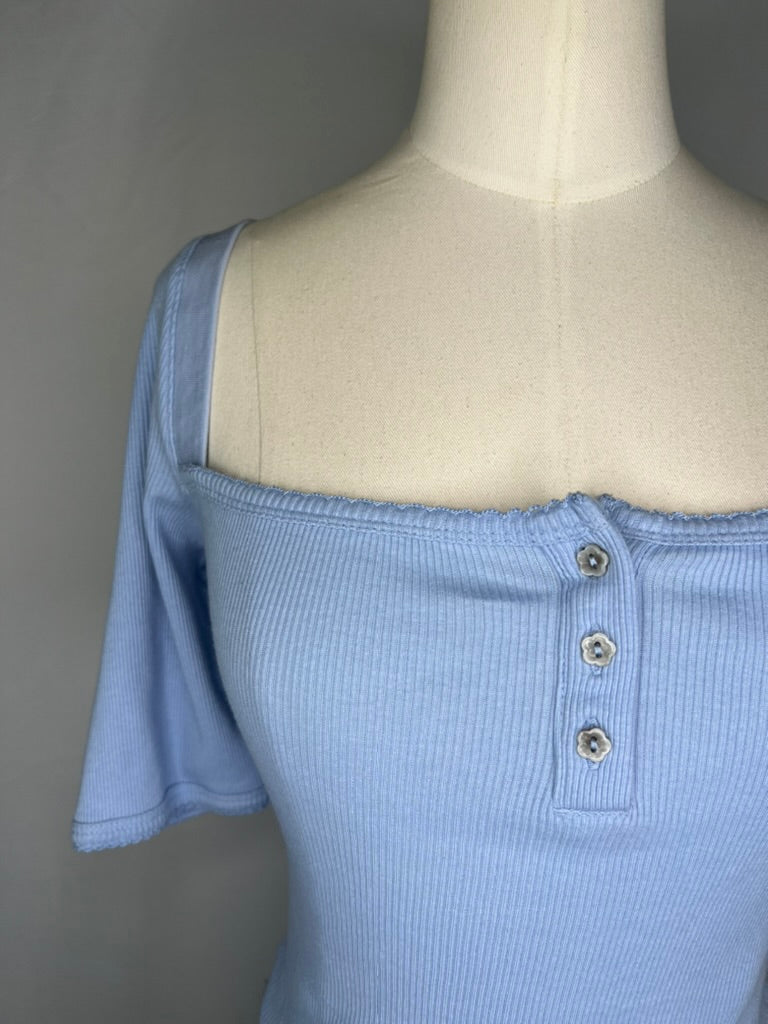 Up close front view number 2 of Urban Outfitters Square Neck Crop Top in Light Blue featuring the ribbed detailing, square neckline, and the 3 flower shaped buttons.