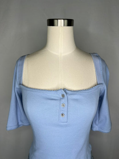 Up close front view of Urban Outfitters Square Neck Crop Top in Light Blue featuring the three flower shaped buttons and square neckline. 