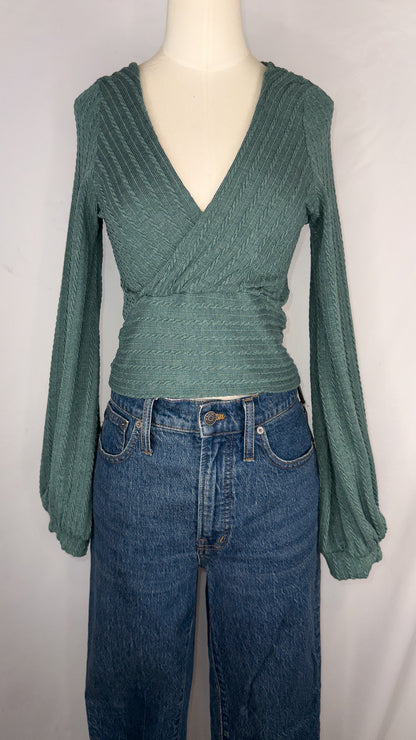 Front view of ZAFUL Ribbed Knit Cropped Wrap Top in Green. The top is shown being paired with a dark blue jean.